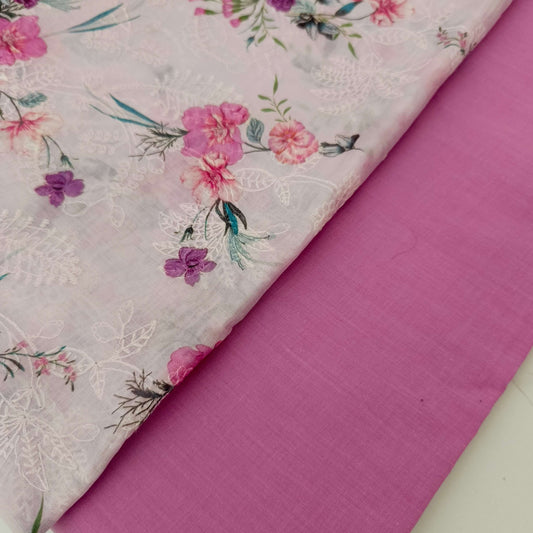 Floral fabric with pink flowers and green leaves on a pink background