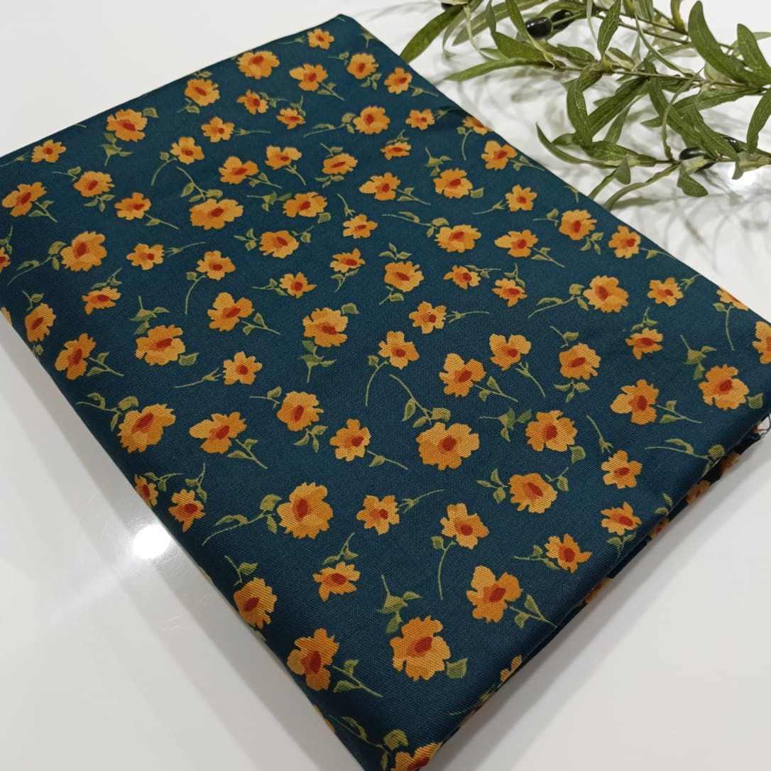 Floral patterned fabric with orange flowers on a dark blue background