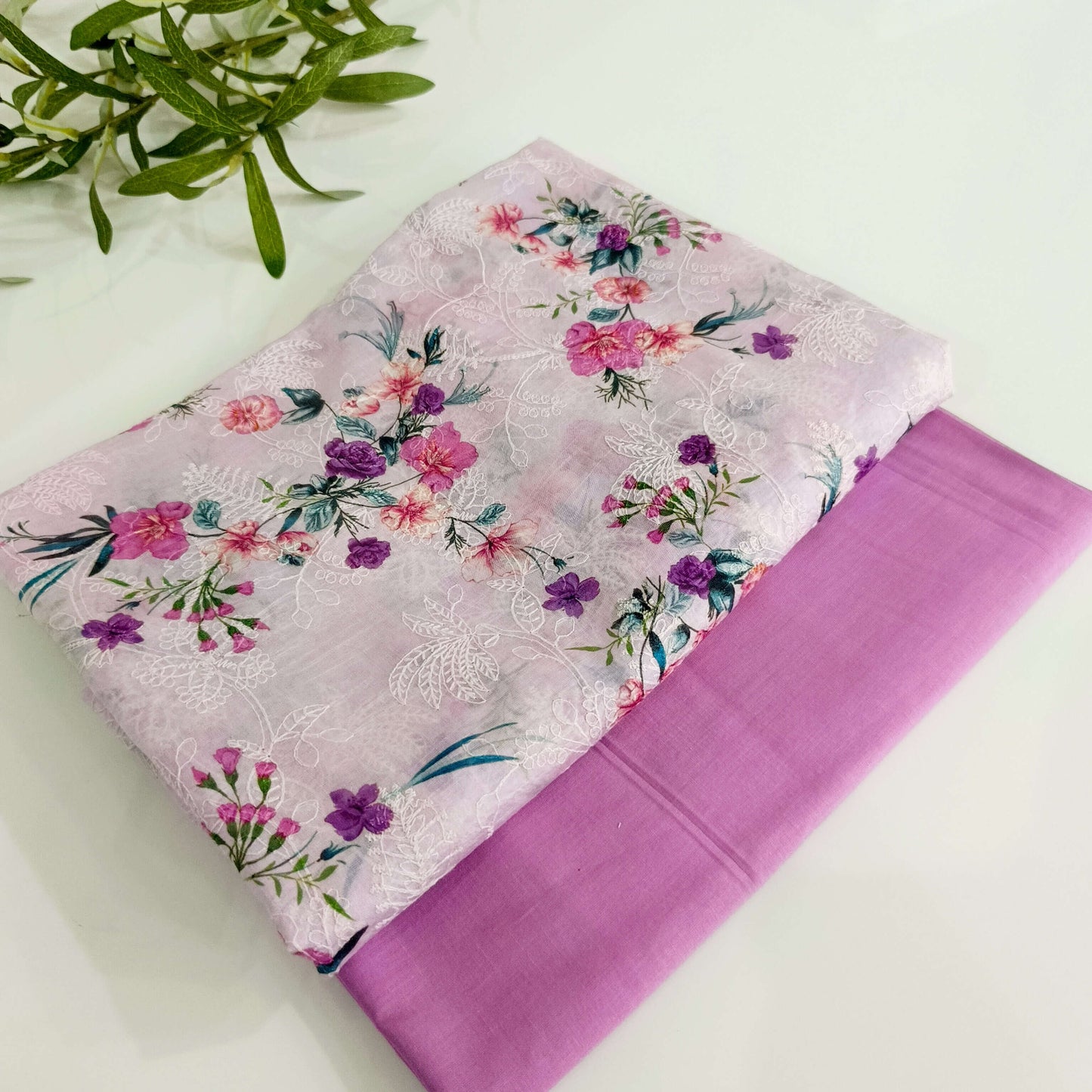 Floral fabric with pink and purple flowers on a white background