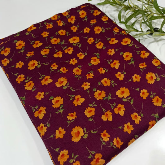Floral fabric with orange flowers on a purple background