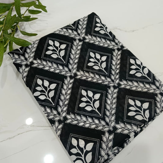 Black fabric with white geometric pattern on a white surface