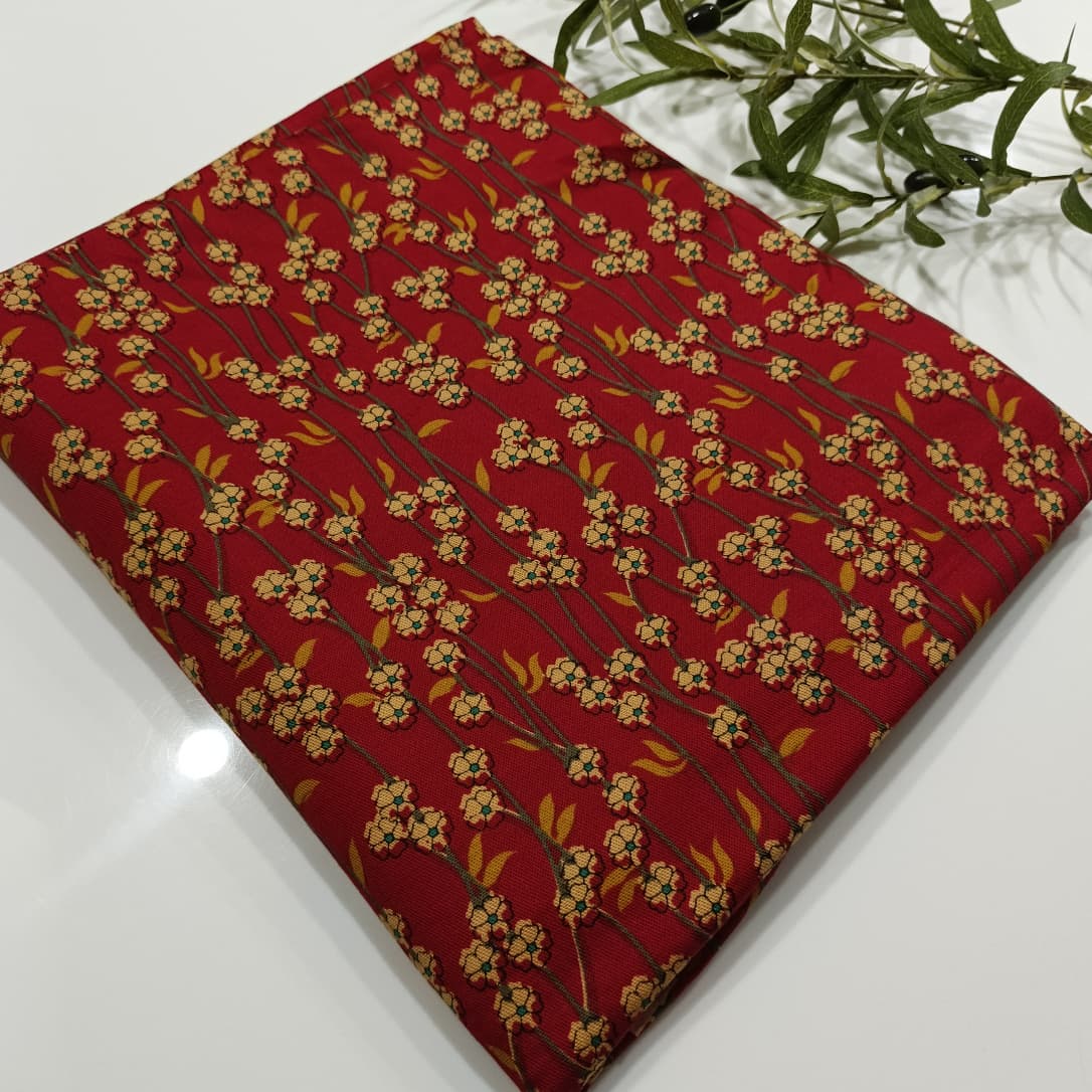Red fabric with floral pattern on a white surface