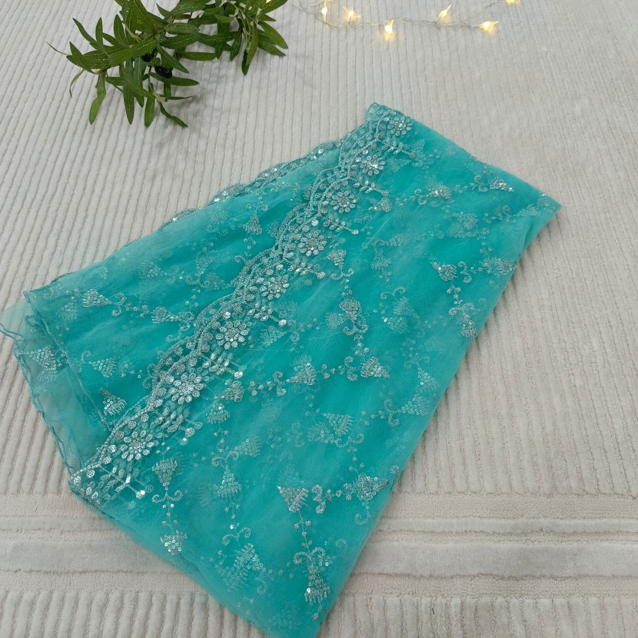 Turquoise fabric with floral embroidery on a textured surface
Celebrate Eid with Noor-e-Zar Collection - Flat 25% Off Festive Pakistani Dresses Online