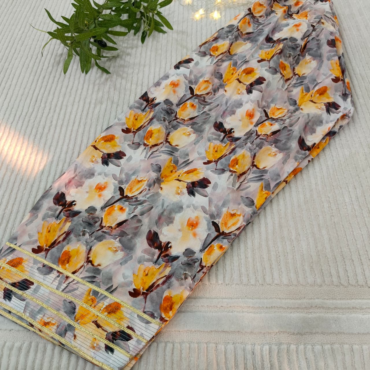 Floral-patterned fabric with yellow and gray flowers on a textured surface
Celebrate Eid with Noor-e-Zar Collection - Flat 25% Off Festive Pakistani Dresses Online